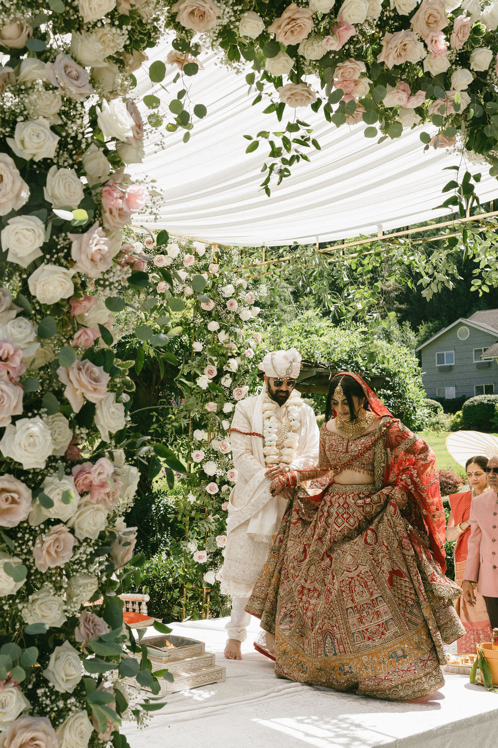 Indian bride and groom walking around the sacred fire during their South Asian wedding ceremony at Carnation Farms, WA